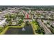 Areal view of the property showcases the pond, landscaping, and surrounding community at 4734 67Th N Ave, Pinellas Park, FL 33781