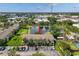 Aerial shot of townhome featuring mature trees, a pond with a fountain, and ample parking at 4734 67Th N Ave, Pinellas Park, FL 33781
