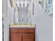 Stylish powder room features a modern vanity, decorative mirror, and seaside accents at 4734 67Th N Ave, Pinellas Park, FL 33781