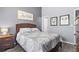 Bedroom with gray walls, wood-look flooring, and decorative 'Stay Awhile' wall art at 4734 67Th N Ave, Pinellas Park, FL 33781