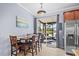Bright eat-in kitchen with sliding glass doors that lead to a screened-in patio and lake view at 4734 67Th N Ave, Pinellas Park, FL 33781