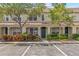Charming townhome with lush landscaping, a beautiful front door wreath, and reserved parking spaces at 4734 67Th N Ave, Pinellas Park, FL 33781