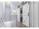 Hallway laundry area with a white barn door and stacked washer and dryer at 4734 67Th N Ave, Pinellas Park, FL 33781