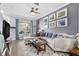 Stylish living room featuring hardwood floors, a large sectional sofa, and wall decorations at 4734 67Th N Ave, Pinellas Park, FL 33781