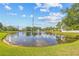 Community pond featuring lush grass, a fountain, and no swimming or boating allowed signage at 4734 67Th N Ave, Pinellas Park, FL 33781