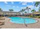 Resort-style pool surrounded by palm trees and lounge chairs for relaxing in the sun at 4734 67Th N Ave, Pinellas Park, FL 33781