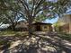 Charming single-Gathering home featuring stone accents, mature shade trees, and a driveway for convenient parking at 484 Itasca Ave, Tampa, FL 33606