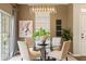 Stylish dining area with a glass-top table, elegant chandelier, and view of the sliding glass door at 5127 6Th N Way, St Petersburg, FL 33703
