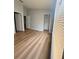 Bedroom featuring an open closet and updated flooring at 6025 Osprey Lake Cir, Riverview, FL 33578