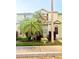 Inviting townhome with mature palm trees and colorful flowerbeds at 6025 Osprey Lake Cir, Riverview, FL 33578
