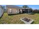 A view of the home's exterior, showcasing a spacious lawn and a screened-in porch for outdoor enjoyment at 6118 Becklin Pl, Riverview, FL 33578