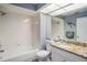 Bathroom features a shower-tub combo, a granite vanity, and decorative ocean themed accents at 6118 Becklin Pl, Riverview, FL 33578