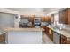 Well-lit kitchen features stainless steel appliances, granite countertops, and wood flooring at 6118 Becklin Pl, Riverview, FL 33578