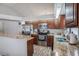 Well-lit kitchen features stainless steel appliances, granite countertops, and wood flooring at 6118 Becklin Pl, Riverview, FL 33578