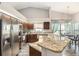Bright kitchen features stainless steel appliances, granite countertops, and breakfast bar seating at 6118 Becklin Pl, Riverview, FL 33578