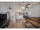 Open-concept living room view to the kitchen featuring wood flooring and vaulted ceilings at 6118 Becklin Pl, Riverview, FL 33578
