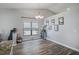 Well-lit living room features wood flooring, vaulted ceilings, and ample natural light at 6118 Becklin Pl, Riverview, FL 33578