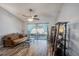 Spacious living room featuring ceiling fan, sliding door to patio, and stylish decor at 6118 Becklin Pl, Riverview, FL 33578