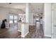 Living room with wood flooring and view to hall at 6118 Becklin Pl, Riverview, FL 33578