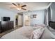 Comfortable main bedroom with wood flooring, ensuite bathroom, and walk-in closet at 6118 Becklin Pl, Riverview, FL 33578