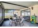 Relaxing screened patio with table, chairs, and a view of the backyard at 6118 Becklin Pl, Riverview, FL 33578