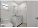 Bathroom features a white vanity with marble countertop and neutral tile flooring at 6471 109Th N Ter, Pinellas Park, FL 33782