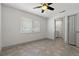 Bright bedroom with adjacent bathroom showcasing tile flooring, a window, and modern trim at 6471 109Th N Ter, Pinellas Park, FL 33782