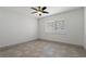 Neutral bedroom with tile flooring, large window, and modern trim, ready for personalization at 6471 109Th N Ter, Pinellas Park, FL 33782
