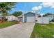 Charming single-Gathering home featuring a clean-cut lawn, driveway, and freshly painted garage door at 6471 109Th N Ter, Pinellas Park, FL 33782