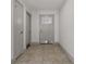Neutral hallway showcasing tile floors, fresh white walls, and modern trim at 6471 109Th N Ter, Pinellas Park, FL 33782