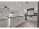 Bright, open kitchen with white cabinetry, granite counters, stainless steel appliances, and a center island at 6471 109Th N Ter, Pinellas Park, FL 33782