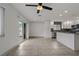 Spacious living room with tile floors and a view to the kitchen and backyard through sliding glass doors at 6471 109Th N Ter, Pinellas Park, FL 33782
