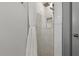Elegant shower with marble-look tiles and shower caddy for toiletries at 6471 109Th N Ter, Pinellas Park, FL 33782