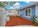 Stylish side yard featuring a small seating area and mulch bed adjacent to the side of the home at 6471 109Th N Ter, Pinellas Park, FL 33782