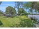 Spacious backyard featuring lush lawn and lake views at 6520 Meadowbrook Ln, New Port Richey, FL 34653