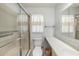 Inviting bathroom includes a glass enclosed shower, tiled accents, and a spacious vanity with ample counter space at 6520 Meadowbrook Ln, New Port Richey, FL 34653
