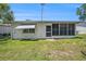 Exterior of home featuring awning and screened-in porch at 6520 Meadowbrook Ln, New Port Richey, FL 34653
