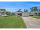 Inviting single-story home with lush lawn, garden, and an attached one-car garage at 6520 Meadowbrook Ln, New Port Richey, FL 34653