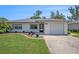Charming single-story home with well-manicured lawn and attached one car garage at 6520 Meadowbrook Ln, New Port Richey, FL 34653