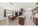 Eat-in kitchen with an adjacent dining area, lots of counter space, and bright lighting at 6520 Meadowbrook Ln, New Port Richey, FL 34653