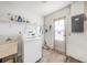 Functional laundry room with a washing machine, sink, and ample storage shelf space for all your cleaning supplies at 6520 Meadowbrook Ln, New Port Richey, FL 34653