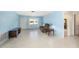 Relaxing living room with tile floors, cozy seating, and abundant natural light at 6520 Meadowbrook Ln, New Port Richey, FL 34653