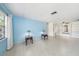 Bright living room featuring tile floors, built-in shelving, and a large window at 6520 Meadowbrook Ln, New Port Richey, FL 34653