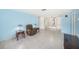Spacious living room with tile flooring, built-in bookshelves, and comfortable seating at 6520 Meadowbrook Ln, New Port Richey, FL 34653