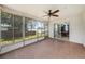 Bright sunroom with tile floor, ceiling fan and beautiful water views at 6520 Meadowbrook Ln, New Port Richey, FL 34653
