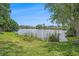Scenic lakefront view showcasing lush greenery, blue skies, and tranquil waters at 6520 Meadowbrook Ln, New Port Richey, FL 34653