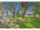 Expansive backyard with verdant lawn, mature trees, and a storage shed, great for outdoor activities at 7318 Lamplighter St, Spring Hill, FL 34606