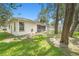 Spacious backyard featuring lush green grass and mature trees, offering privacy and shade at 7318 Lamplighter St, Spring Hill, FL 34606