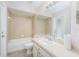 Well-lit bathroom with vanity, mirror, tub and shower combo at 7318 Lamplighter St, Spring Hill, FL 34606