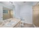 Bright bathroom with tiled shower, large mirror, and neutral countertop at 7318 Lamplighter St, Spring Hill, FL 34606